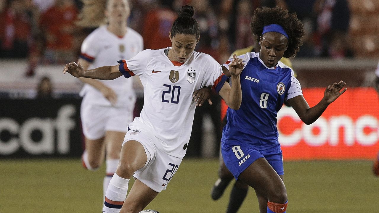 HOUSTON, TEXAS - JANUARY 28: Christen Press #20 of the United States competes for the ball with Danielle Etienne #8 of Haiti during a Group A CONCACAF Women's Olympic Qualifying match at BBVA Compass Stadium on January 28, 2020 in Houston, Texas. (Photo by Bob Levey/Getty Images)