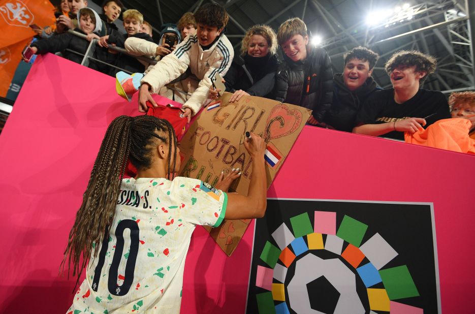 Silva signs autographs for fans after the match.