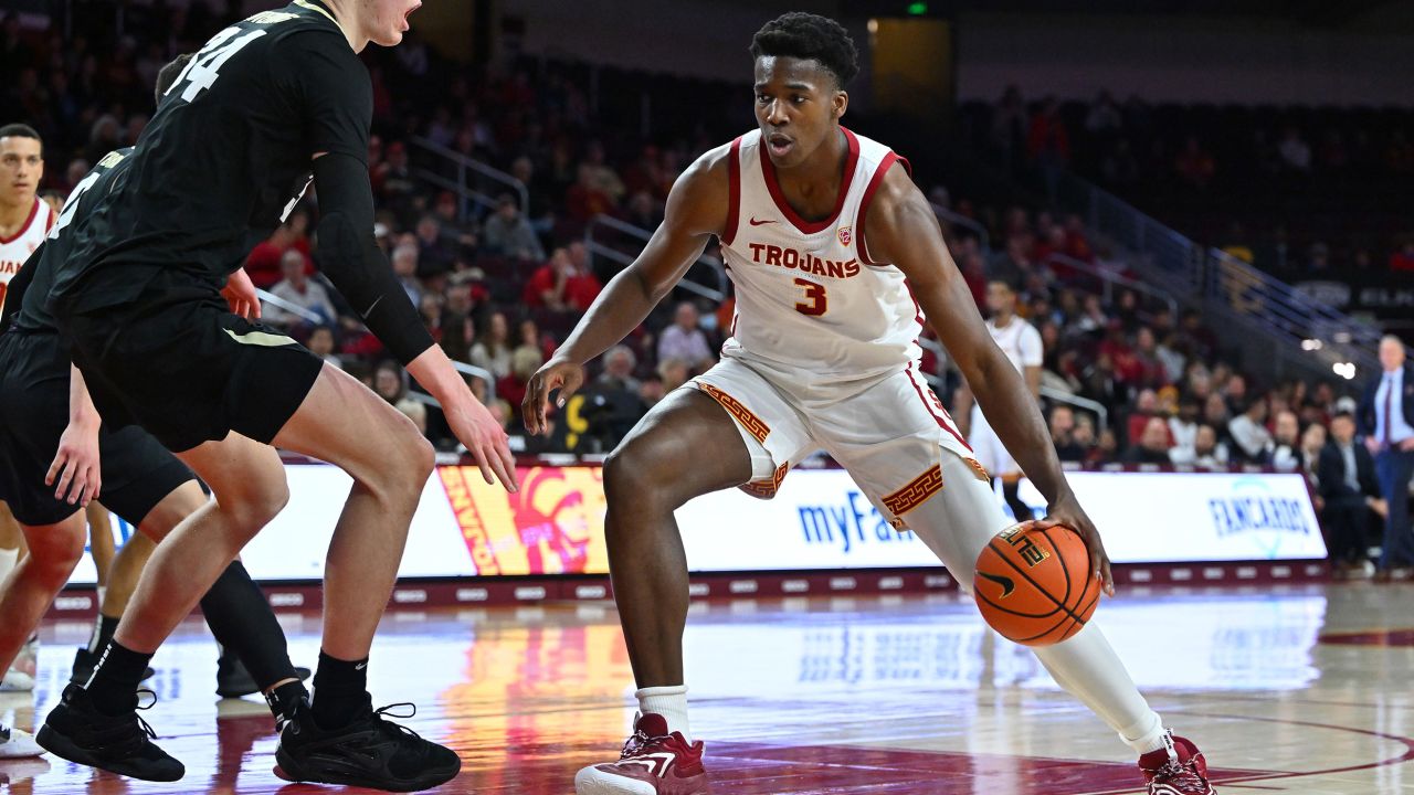 Vince Iwuchukwu of the USC Trojans is defended by Lawson Lovering of the Colorado Buffaloes on January 12 during his first game since his cardiac arrest.