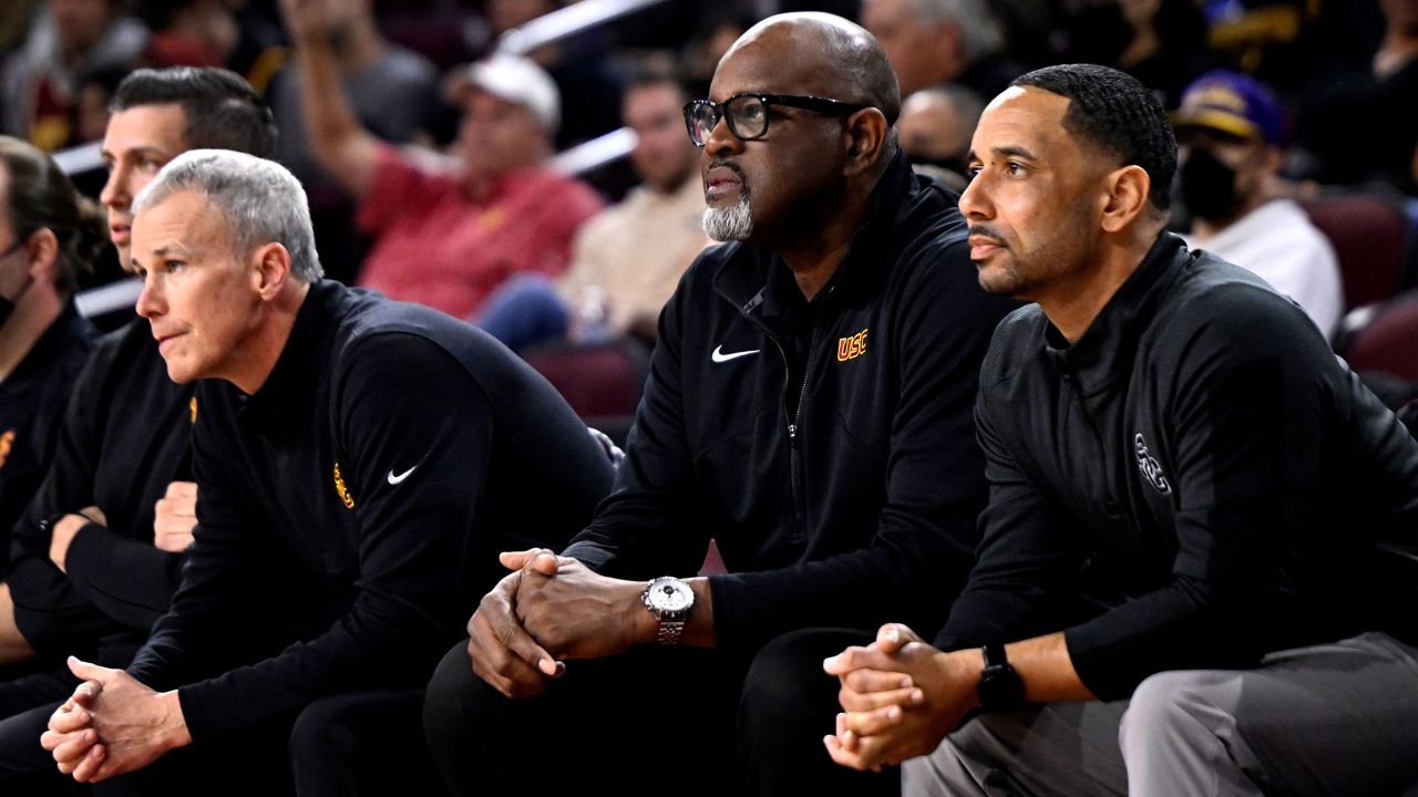 USC head coach Andy Enfield, left, along with Assistant Coach Eric Mobley, center, and Assistant Coach Jay Morris look on at a Trojans game on February 17, 2022.