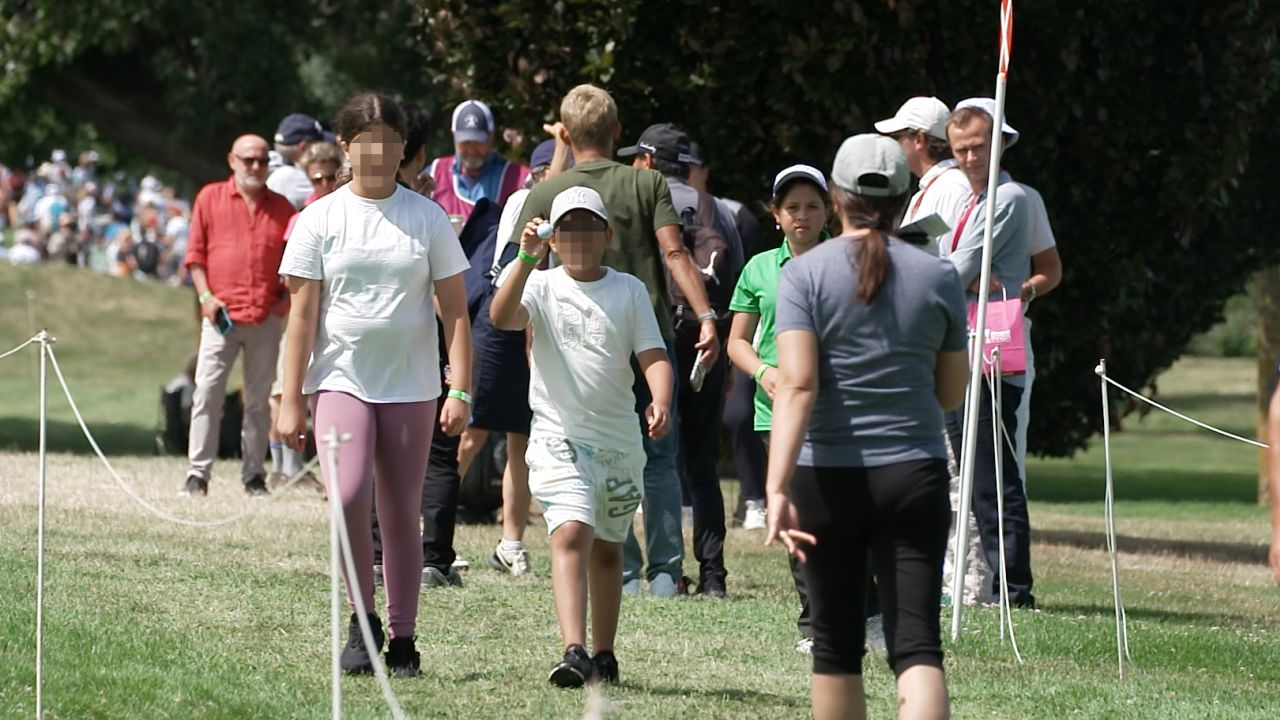 The boy and his sister return with balls signed by Angel Yin. A portion of this image has been blurred by CNN to protect identity.