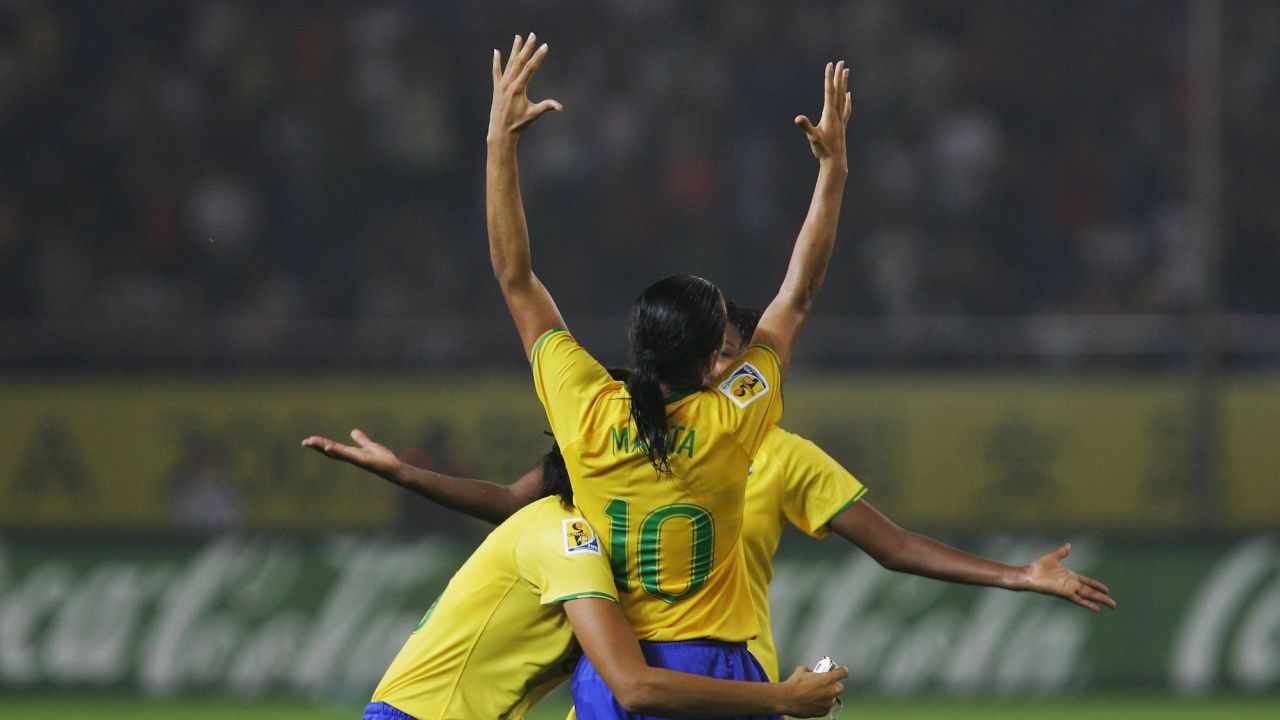 HANGZHOU, ZHEJIANG - SEPTEMBER 27:  Marta(10#)  of Brazil celebrates the winning with Monica(L 13#)  after the Womens World Cup 2007 Semi Final match between USA and Brazil at Hangzhou Dragon Stadium on September 27, 2007 in Hangzhou, Zhejiang province of China.  (Photo by Feng Li/Getty Images)