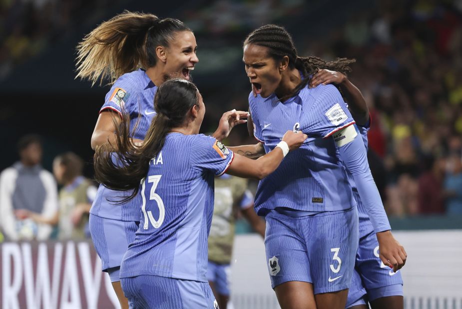 Renard celebrates with teammates after scoring her team's second goal.