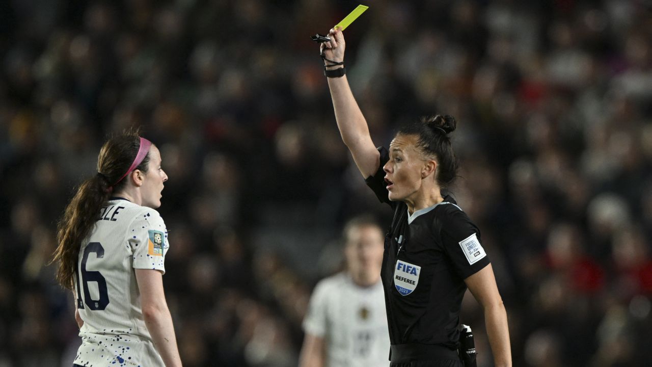 English referee Rebecca Welch (R) shows a yellow card to US midfielder #16 Rose Lavelle (L) in the match against Portugal. Lavelle will now miss her team's last-16 match on Sunday.