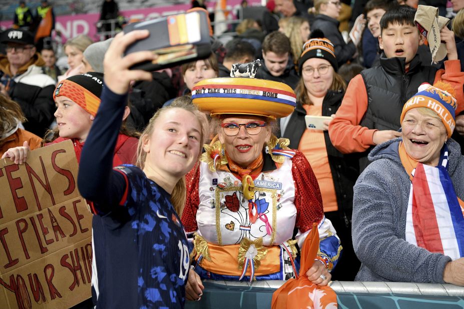 Dutch midfielder Wieke Kaptein takes a selfie with fans after the Netherlands defeated Vietnam 7-0 and advanced to the knockout stage.