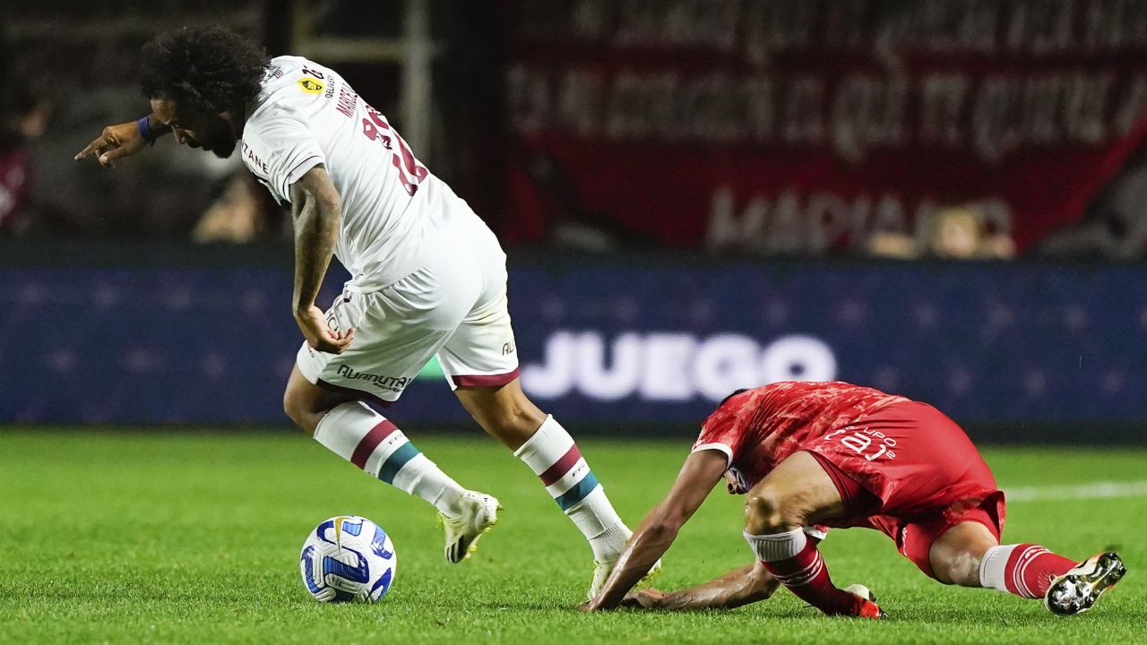 Luciano Sánchez of Argentina's Argentinos Juniors, right, falls injured during a play against Marcelo of Brazil's Fluminense, left, during a Copa Libertadores round of 16 first leg soccer match at Diego Armando Maradona stadium in Buenos Aires, Argentina, Tuesday, Aug. 1, 2023. (AP Photo/Ivan Fernandez)