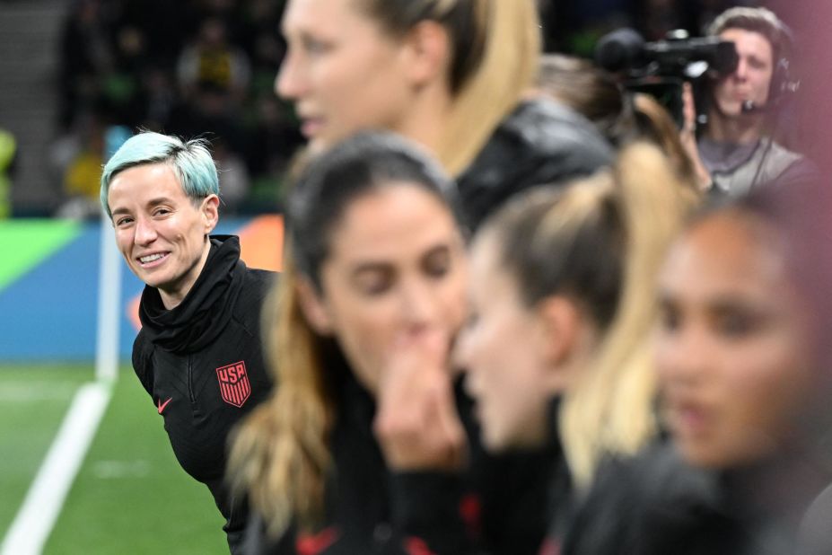 US forward Megan Rapinoe, left, looks on from the substitutes' bench.