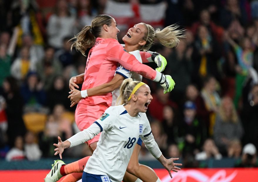 England's Chloe Kelly, center, celebrates as teammates Rachel Daly and goalkeeper Mary Earps after scoring her team's fifth and winning penalty in a shootout during the match between England and Nigeria, at Brisbane Stadium in Brisbane, Australia, on Monday, August 7. England goes through to the quarterfinals <a href="https://edition.cnn.com/2023/08/06/football/england-nigeria-australia-denmark-womens-world-cup-2023-spt-intl/index.html" target="_blank">after winning the penalty shootout</a> 4-2 over Nigeria.