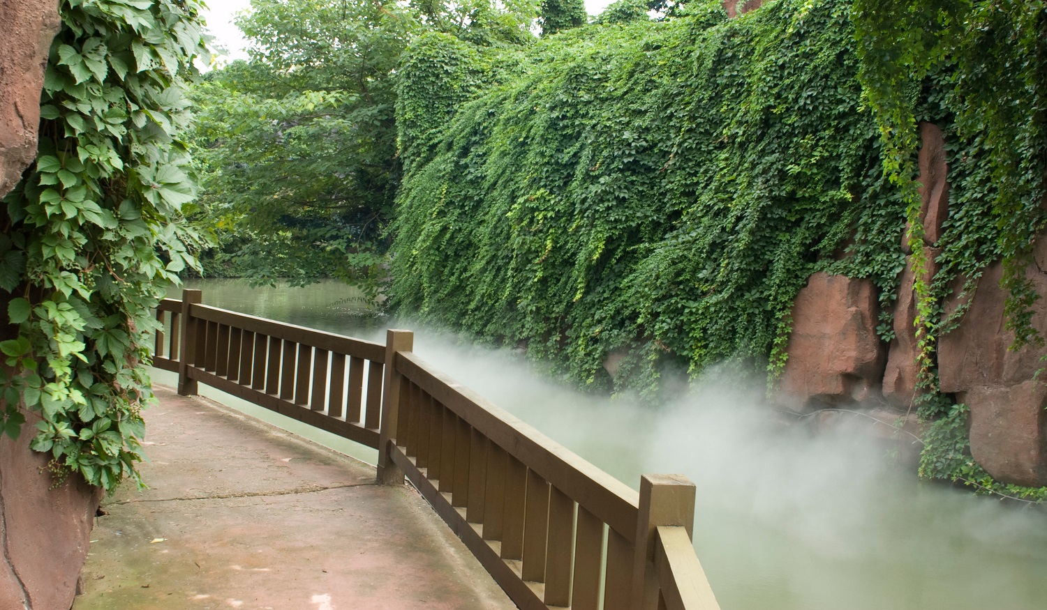 Steam rises beneath a walkway in the China Dinosaur Park, a theme park in Changzhou, China.