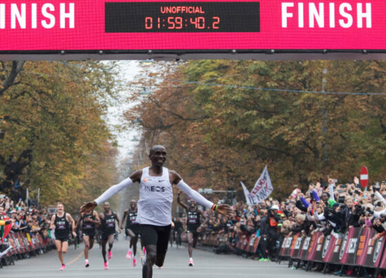 Eliud Kipchoge spreads his arms in jubilation as he finishes a sub 2 hour unofficial marathon in Vienna.