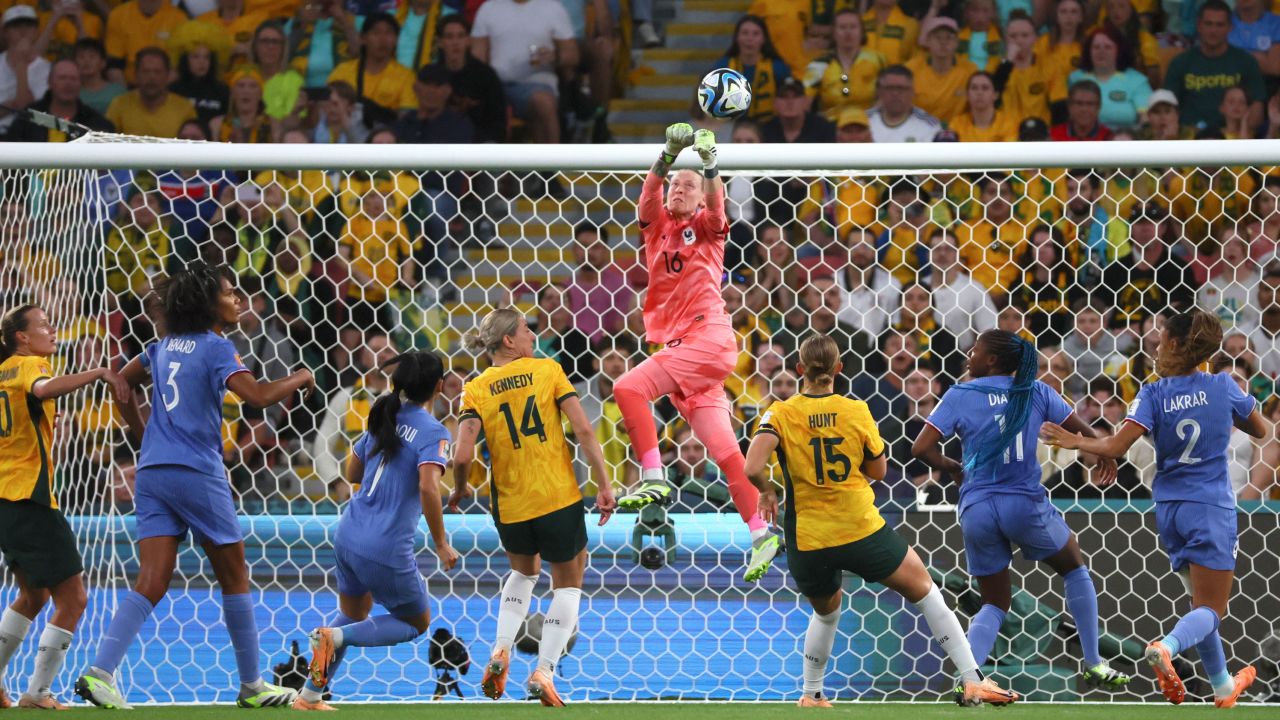 France's goalkeeper Pauline Peyraud-Magnin, centre, punches the ball away during the quarterfinal match.