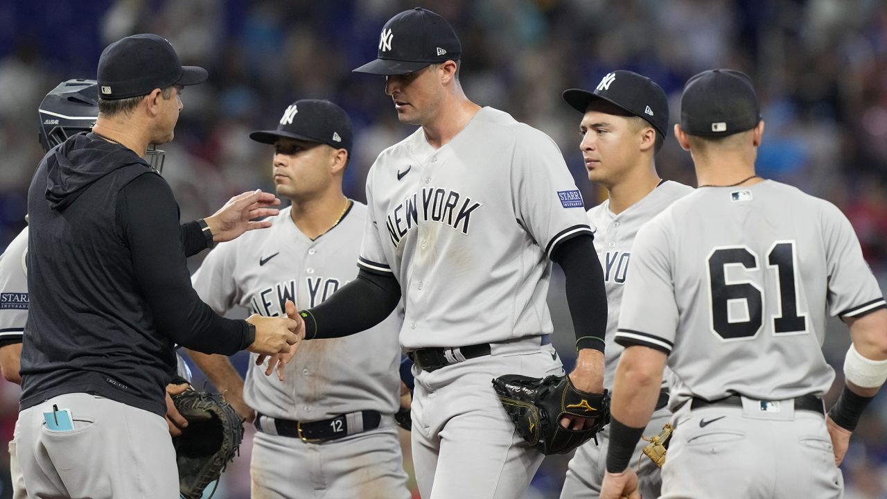 New York Yankees manager Aaron Boone relieves pitcher Clay Holmes during the ninth inning of a baseball game against the Miami Marlins, Sunday, Aug. 13, 2023, in Miami. (AP Photo/Marta Lavandier)