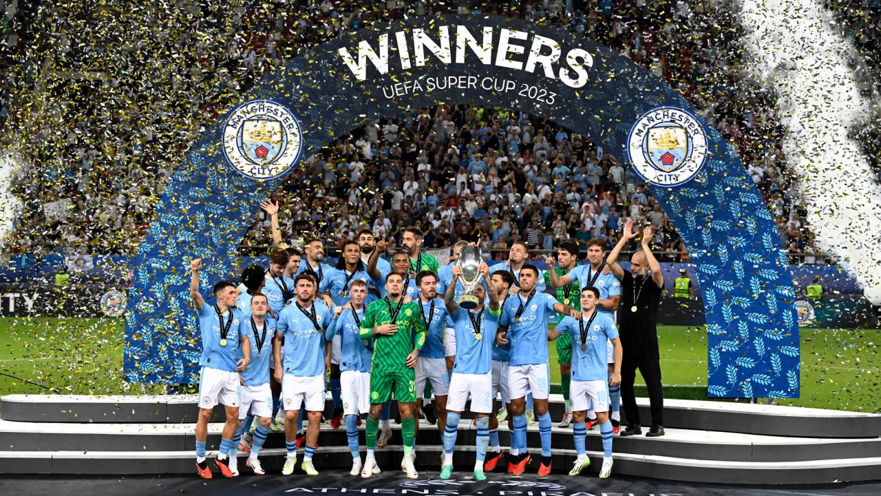 Manchester City's English defender #02 Kyle Walker holds the trophy on the podium after winning the 2023 UEFA Super Cup football match between Manchester City and Sevilla at the Georgios Karaiskakis Stadium in Piraeus on August 16, 2023. (Photo by Aris MESSINIS / AFP) (Photo by ARIS MESSINIS/AFP via Getty Images)