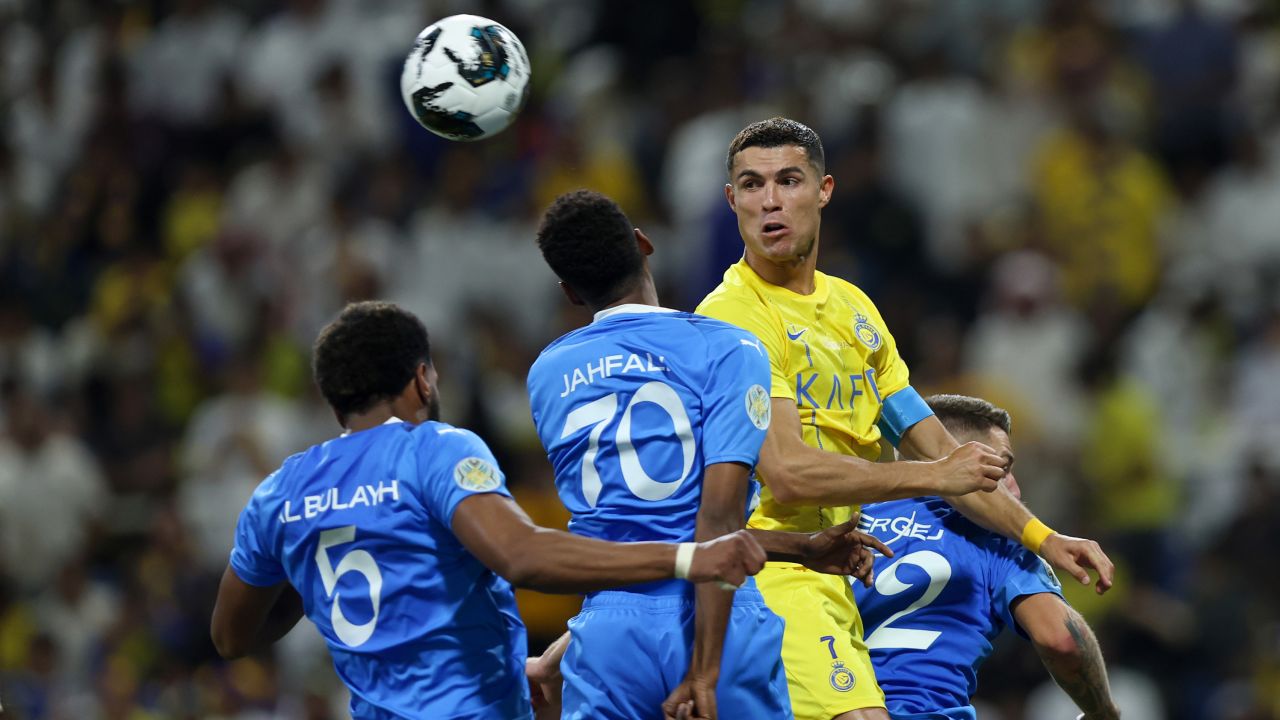 RIYADH, SAUDI ARABIA - AUGUST 12: Cristiano Ronaldo of Al Nassr and Mohammed Jahfali of Al Hilal battle for a header during the Arab Club Champions Cup Final between Al Hilal and Al Nassr at King Fahd International Stadium on August 12, 2023 in Riyadh, Saudi Arabia. (Photo by Yasser Bakhsh/Getty Images)