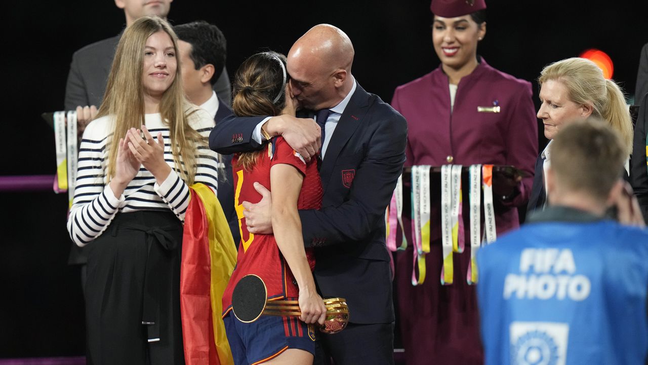 President of Spain's soccer federation, Luis Rubiales, right, hugs Spain's Aitana Bonmati on the podium following Spain's win in the final of Women's World Cup soccer against England at Stadium Australia in Sydney, Australia, Sunday, Aug. 20, 2023. At left is Spain's Princess Infanta Sofia. (AP Photo/Alessandra Tarantino)