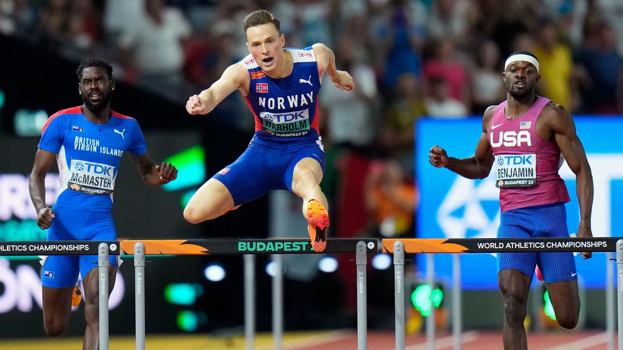 Karsten Warholm, of Norway clears the final hurdle ahead of Kyron Mcmaster, of the British Virgin Islands and Rai Benjamin, of the United States to win the gold medal in the Men's 400-meters hurdles final during the World Athletics Championships in Budapest, Hungary, Wednesday, Aug. 23, 2023.(AP Photo/Petr David Josek)