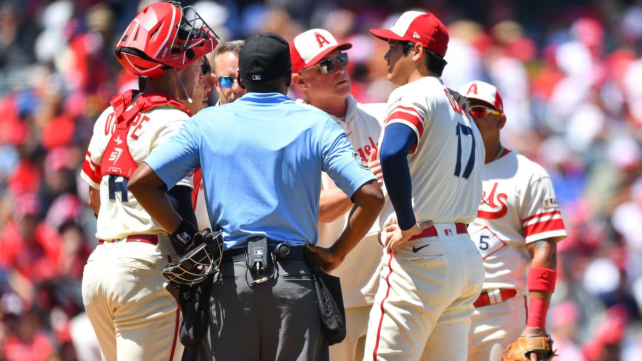 ANAHEIM, CA - AUGUST 23: Manager Phil Nevin checks on Los Angeles Angels pitcher Shohei Ohtani (17) during the MLB game 1 of a doubleheader between the Cincinnati Reds and the Los Angeles Angels of Anaheim on August 23, 2023 at Angel Stadium of Anaheim in Anaheim, CA. (Photo by Brian Rothmuller/Icon Sportswire via Getty Images)