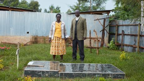 Agnes' parents, Dinah and Vincent Tirop, visit their daughter's grave in the back of the family home in Nandi County.