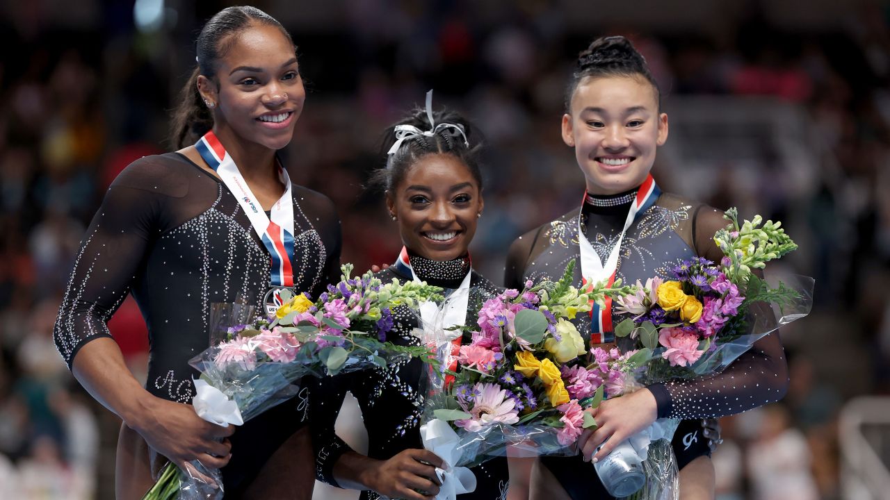 Simone Biles (center) poses with Shilese Jones (left) and Leanne Wong on the podium after the three medaled at the US Gymnastics Championships on Sunday.