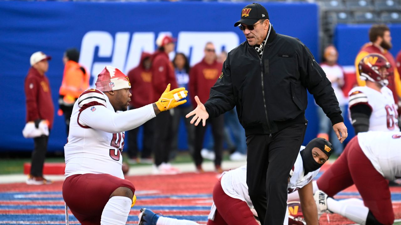 Commanders defensive tackle Daron Payne (94) shakes hands with Washington Commanders head coach Ron Rivera.