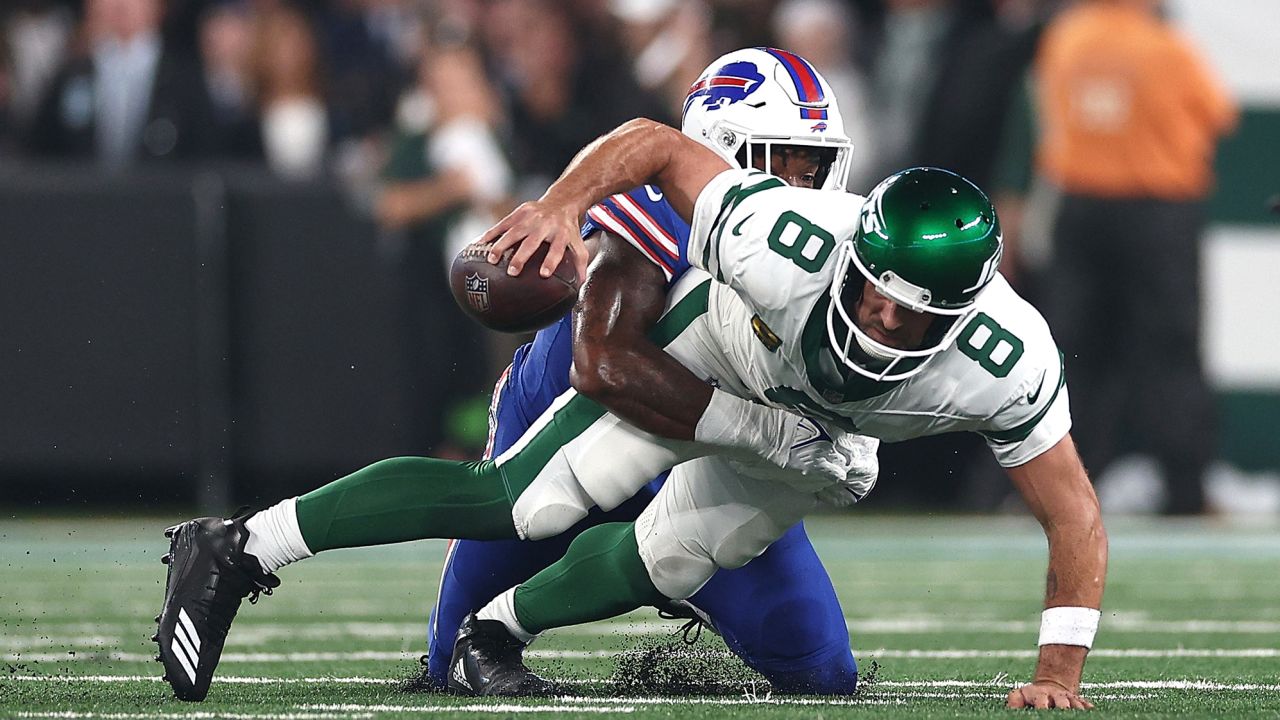 EAST RUTHERFORD, NEW JERSEY - SEPTEMBER 11: Quarterback Aaron Rodgers #8 of the New York Jets sacked by defensive end Leonard Floyd #56 of the Buffalo Bills during the first quarter of the NFL game at MetLife Stadium on September 11, 2023 in East Rutherford, New Jersey. (Photo by Elsa/Getty Images)