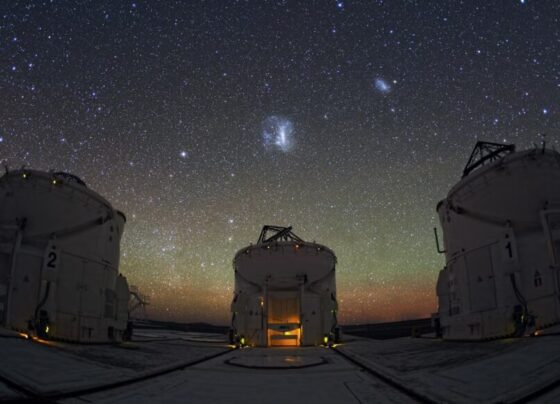 A photo of part of the Paranal Observatory in Chile with the Large Magellanic Cloud visible in the center and Small Magellanic Cloud visible on the right.