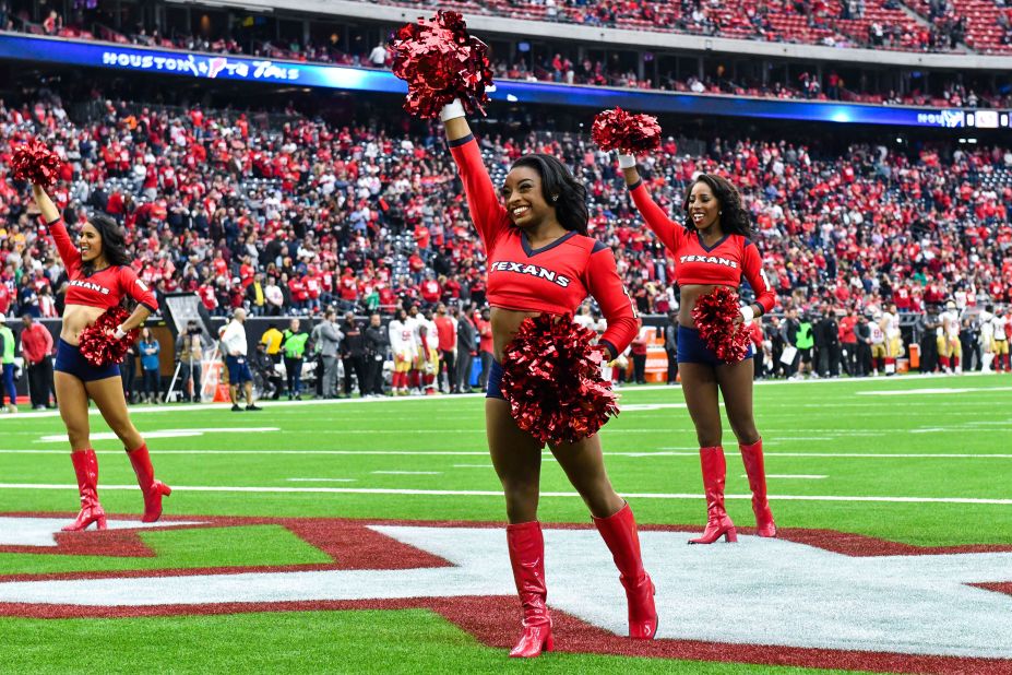 Biles performs with the Houston Texans cheerleaders in December 2017.