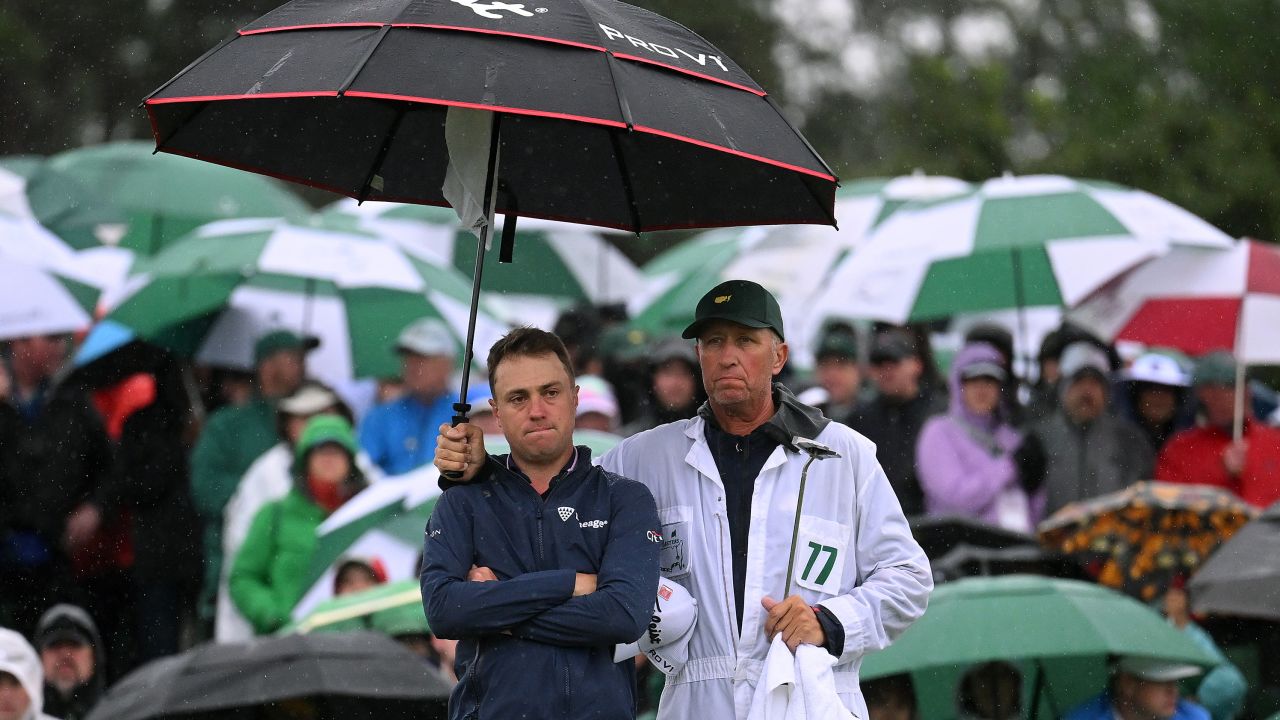 Justin Thomas of the United States and his caddie Jim 'Bones' Mackay react to his bogey on the 18th green  during the continuation of the weather delayed second round of the 2023 Masters Tournament at Augusta National Golf Club on April 08, 2023 in Augusta, Georgia.