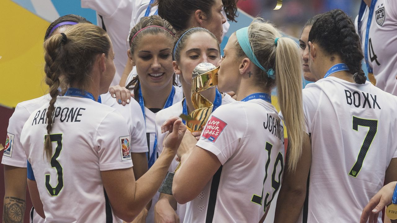 United States' defender Julie Johnston (19) and midfielder Morgan Brian (14) kiss the Women's World Cup trophy after 5-2 victory over Japan in the final match, Monday July 13, 2015 in Vancouver, British Columbia. (Mo Khursheed/TFV Media via AP Images) MANDATORY CREDIT