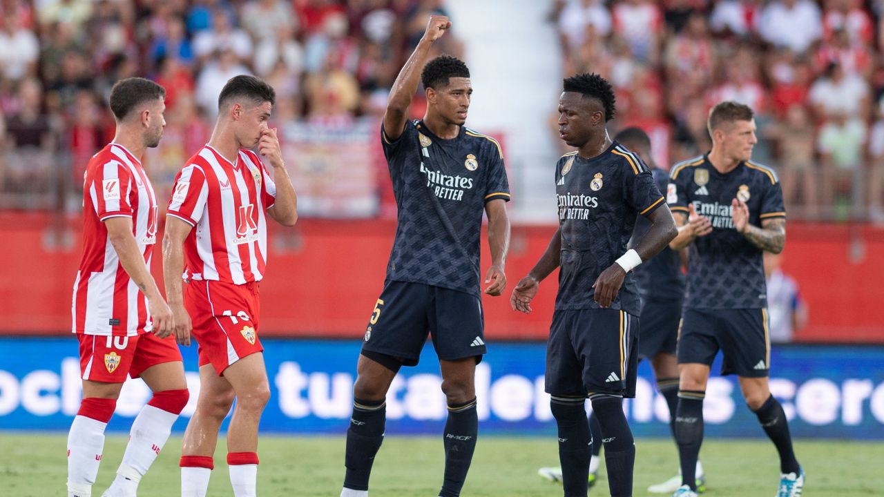 Real Madrid's English midfielder #05 Jude Bellingham (C) celebrates scoring a goal next to Real Madrid's Brazilian forward #07 Vinicius Junior during the Spanish Liga football match between UD Almeria and Real Madrid CF at the Municipal Stadium of the Mediterranean Games in Almeria on August 19, 2023. (Photo by JORGE GUERRERO / AFP) (Photo by JORGE GUERRERO/AFP via Getty Images)