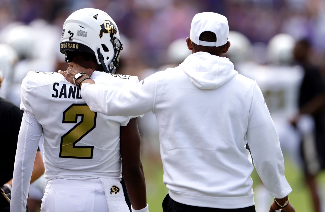 Shedeur Sanders #2 of the Colorado Buffaloes and his father and head coach Deion Sanders walk the sidelines just before the game against the TCU Horned Frogs at Amon G. Carter Stadium on September 2, 2023 in Fort Worth, Texas. Colorado won 45-42.