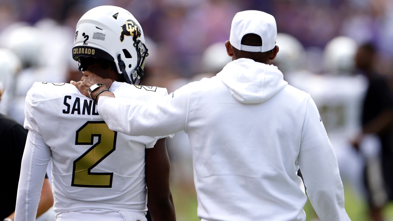 Shedeur Sanders #2 of the Colorado Buffaloes and his father and head coach Deion Sanders walk the sidelines just before the game against the TCU Horned Frogs at Amon G. Carter Stadium on September 2, 2023 in Fort Worth, Texas. Colorado won 45-42.