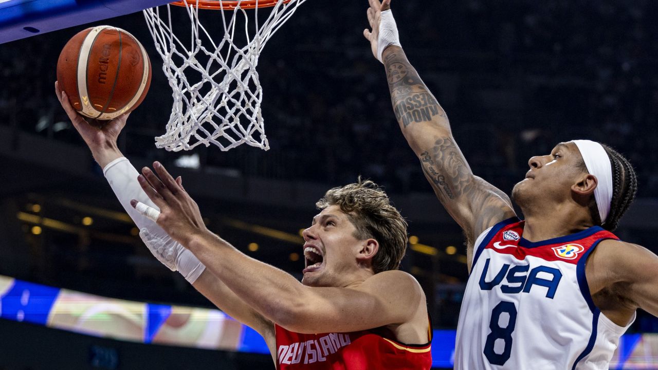 MANILA, PHILIPPINES - SEPTEMBER 08: Moritz Wagner #13 of Germany drives to the basket against Paolo Banchero #8 of the United States during the FIBA Basketball World Cup Semi Final game between USA and Germany at Mall of Asia Arena on September 08, 2023 in Manila, Philippines. (Photo by Ezra Acayan/Getty Images)