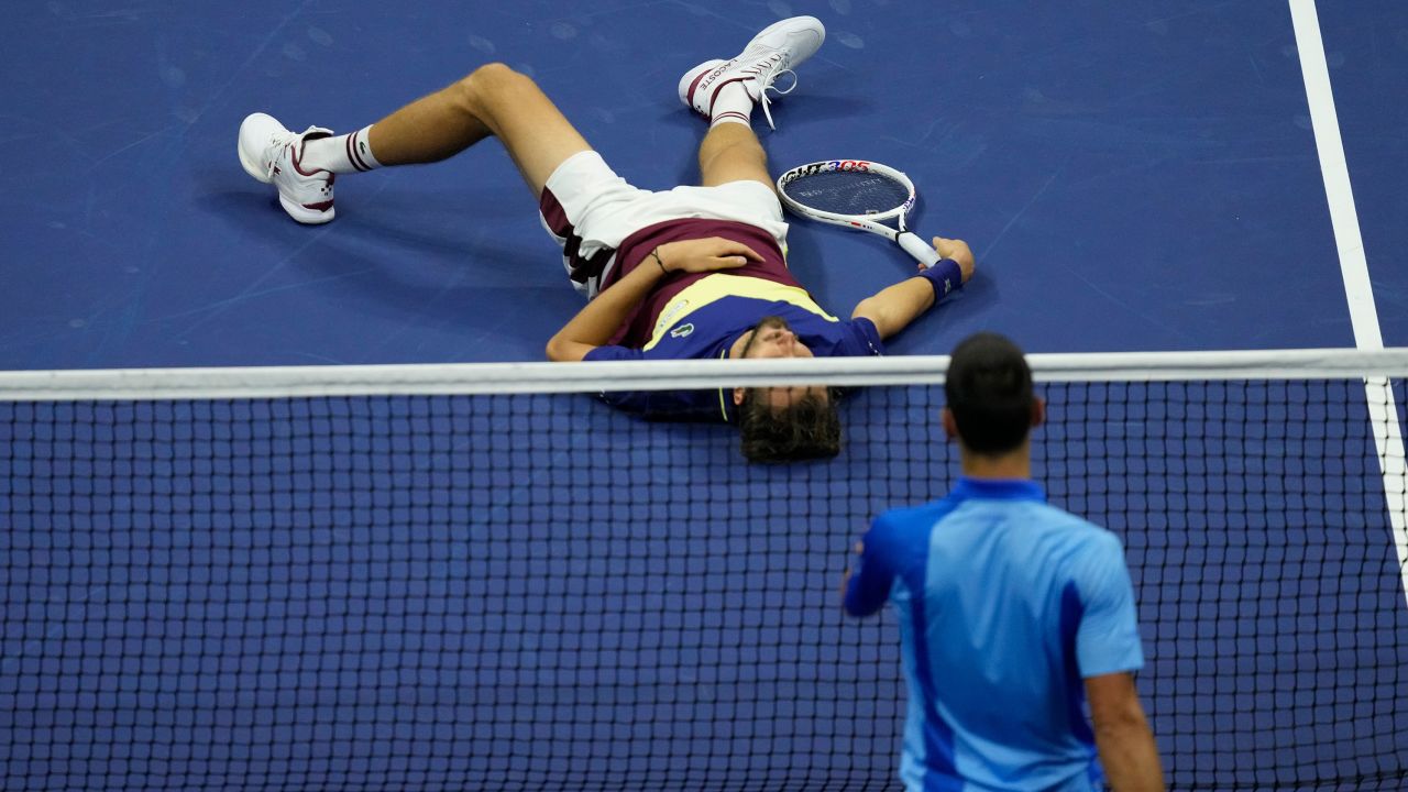 Novak Djokovic, of Serbia, moves to check on Daniil Medvedev, of Russia, who laid on the court after a rally during the men's singles final of the U.S. Open tennis championships, Sunday, Sept. 10, 2023, in New York. (AP Photo/Mary Altaffer)