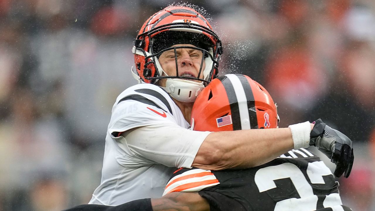 Cincinnati Bengals quarterback Joe Burrow, left, is hit by Cleveland Browns safety Grant Delpit, right, as he throws during the second half of an NFL football game Sunday, Sept. 10, 2023, in Cleveland. (AP Photo/Sue Ogrocki)