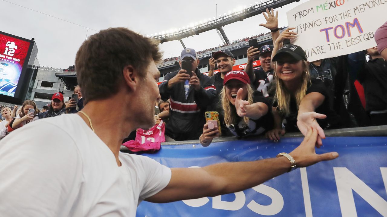 Former New England Patriots' Tom Brady reaches out to fans following a ceremony in his honor during halftime of an NFL football game between the Philadelphia Eagles and the New England Patriots, Sunday, Sept. 10, 2023, in Foxborough, Mass. (AP Photo/Michael Dwyer)