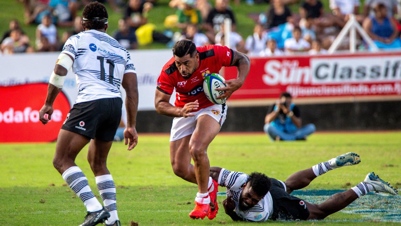 Tonga's Salesi Piutau (C) runs with the ball during the World Rugby Pacific Nations Cup match between Fiji and Tonga at HFC Stadium in Fiji's capital city Suva on July 2, 2022. (Photo by Leon LORD / AFP) (Photo by LEON LORD/AFP via Getty Images)