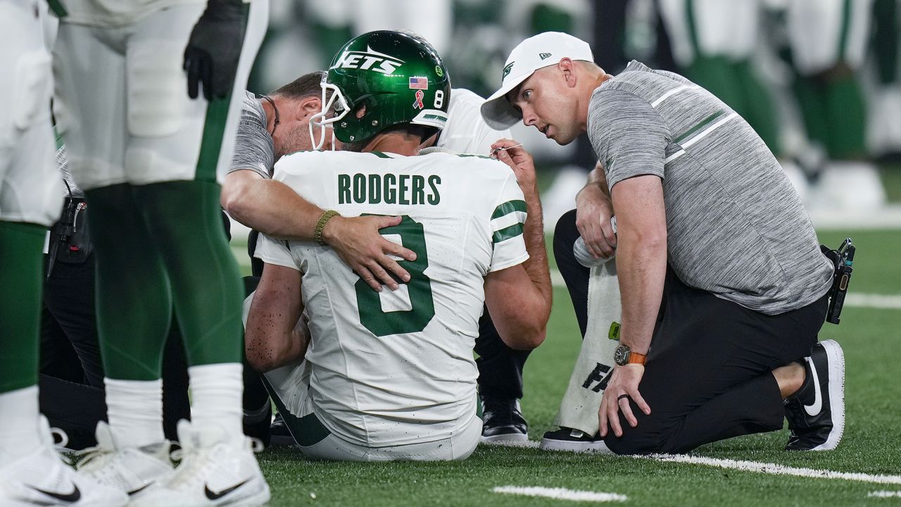 New York Jets quarterback Aaron Rodgers (8) is tended to on the field during the first quarter of an NFL football game against the Buffalo Bills, Monday, Sept. 11, 2023, in East Rutherford, N.J. (AP Photo/Seth Wenig)