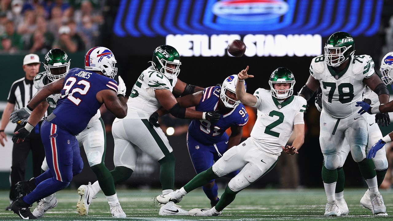 Quarterback Zach Wilson throws a pass under pressure from the Bills' pass rush.