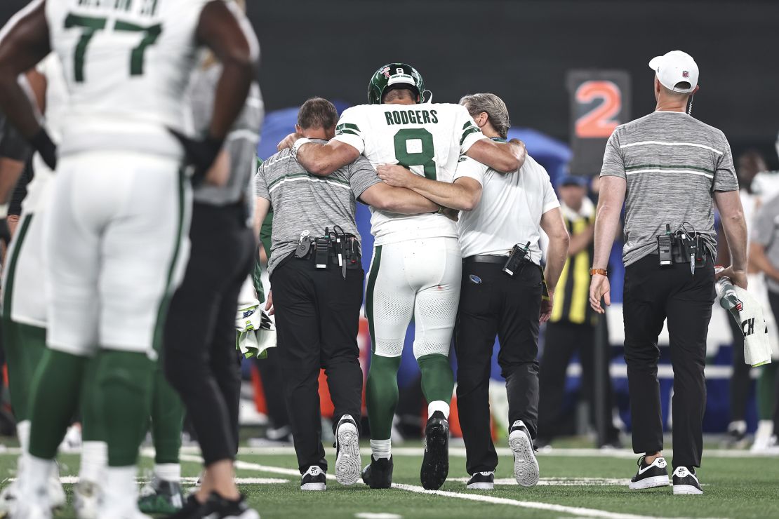 EAST RUTHERFORD, NEW JERSEY - SEPTEMBER 11: Aaron Rodgers #8 of the New York Jets is helped off the field for an apparent injury during a game against the Buffalo Bills at MetLife Stadium on September 11, 2023 in East Rutherford, New Jersey. (Photo by Michael Owens/Getty Images)