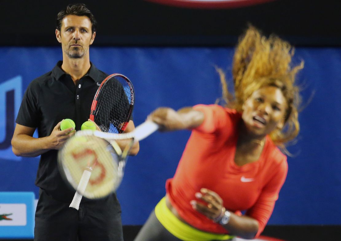 MELBOURNE, AUSTRALIA - JANUARY 06:  Serena Williams of the USA serves as her coach Patrick Mouratoglou looks on during a practice session ahead of the 2014 Australian Open at Melbourne Park on January 6, 2014 in Melbourne, Australia.  (Photo by Scott Barbour/Getty Images)