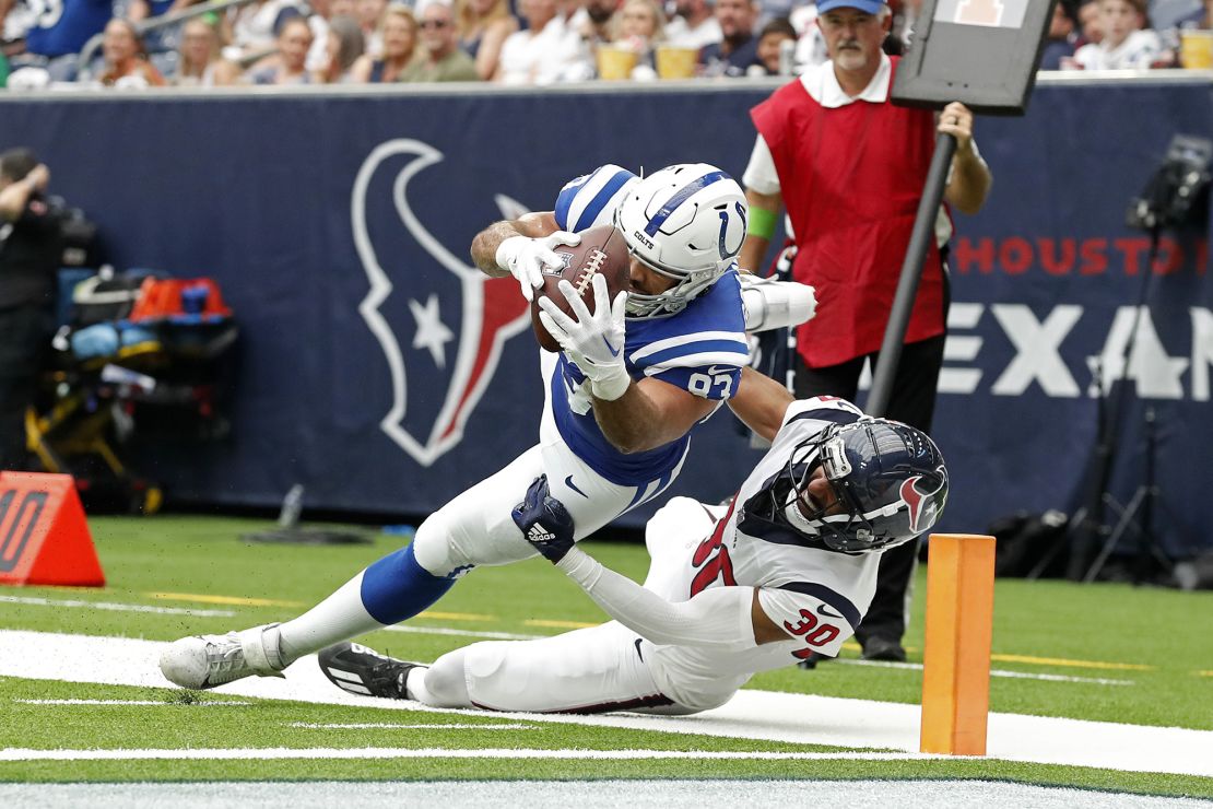 Indianapolis Colts tight end Kylen Granson (83) dives past Houston Texans safety DeAndre Houston-Carson (30) to score a touchdown during an NFL football game, Sunday, Sep. 17, 2023, in Houston. (AP Photo/Tyler Kaufman)