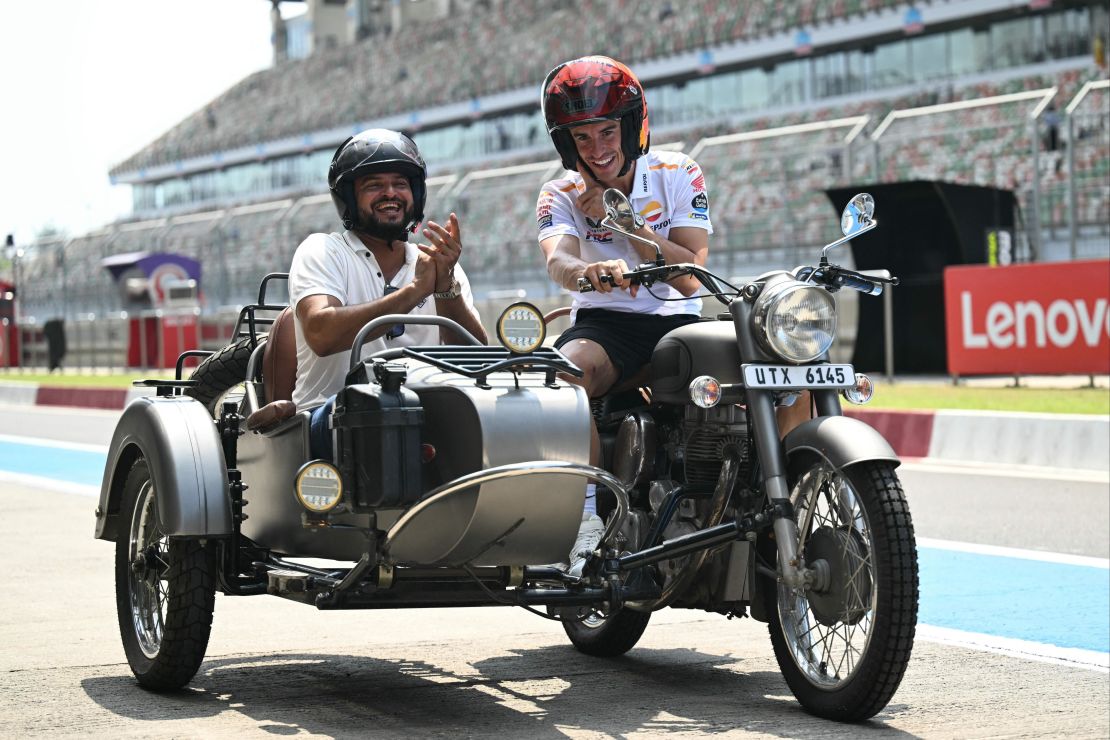 Repsol Honda's Spanish rider Marc Marquez (R) and India's former cricket player Suresh Raina ride on a motorbike ahead of the Indian MotoGP Grand Prix at the Buddh International Circuit in Greater Noida on the outskirts of New Delhi, on September 21, 2023.