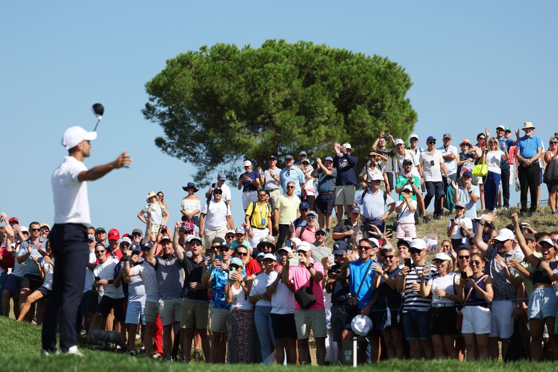 ROME, ITALY - SEPTEMBER 27: Tennis player Novak Djokovic reacts as spectators cheer his tee shot on the 16th hole during the All-Star Match at the 2023 Ryder Cup at Marco Simone Golf Club on September 27, 2023 in Rome, Italy. (Photo by Jamie Squire/Getty Images)