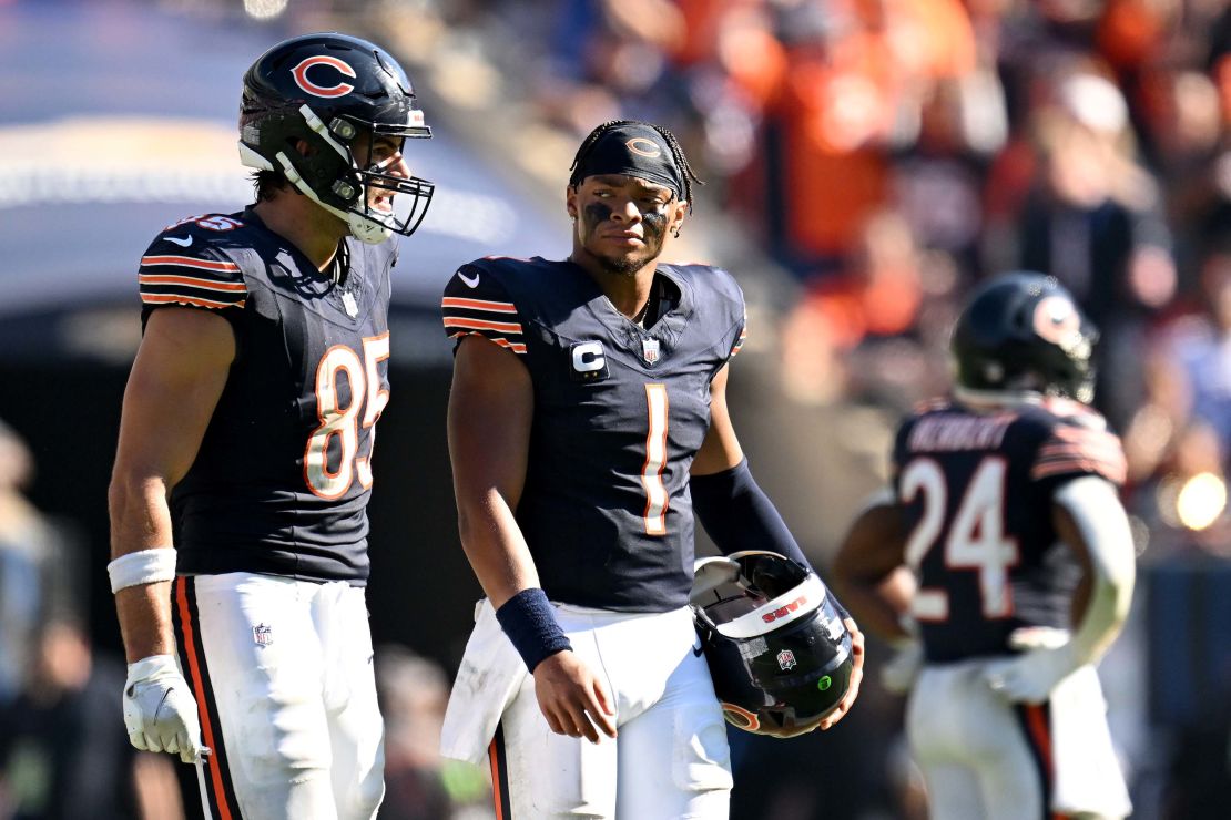 CHICAGO, ILLINOIS - OCTOBER 01: Justin Fields #1 of the Chicago Bears walks with Cole Kmet #85 after throwing an interception against the Denver Broncos during the fourth quarter at Soldier Field on October 01, 2023 in Chicago, Illinois. (Photo by Quinn Harris/Getty Images)