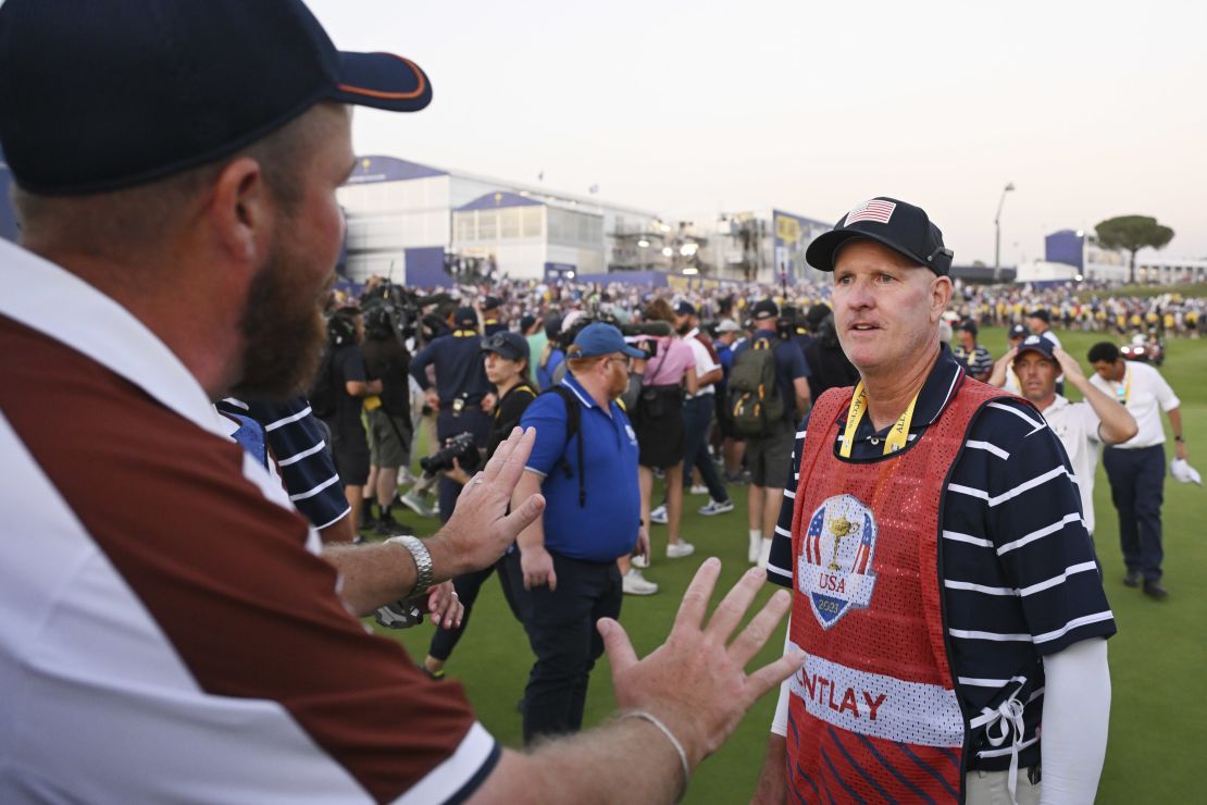 ROME, ITALY - SEPTEMBER 30: Shane Lowry of Team Europe interacts with caddie of Patrick Cantlay of Team United States (not pictured), Joe LaCava on the 18th green during the Saturday afternoon fourball matches of the 2023 Ryder Cup at Marco Simone Golf Club on September 30, 2023 in Rome, Italy. (Photo by Ross Kinnaird/Getty Images)