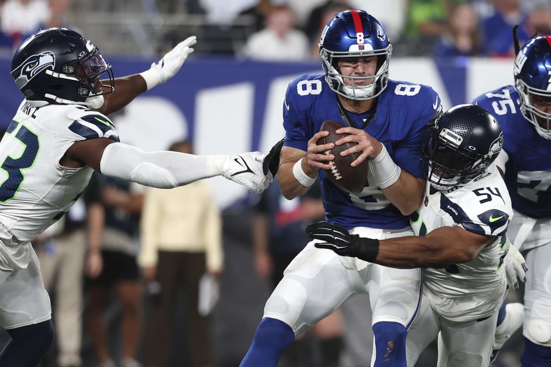 EAST RUTHERFORD, NEW JERSEY - OCTOBER 02: Daniel Jones #8 of the New York Giants is sacked by Bobby Wagner #54 of the Seattle Seahawks during the third quarter at MetLife Stadium on October 02, 2023 in East Rutherford, New Jersey. (Photo by Al Bello/Getty Images)