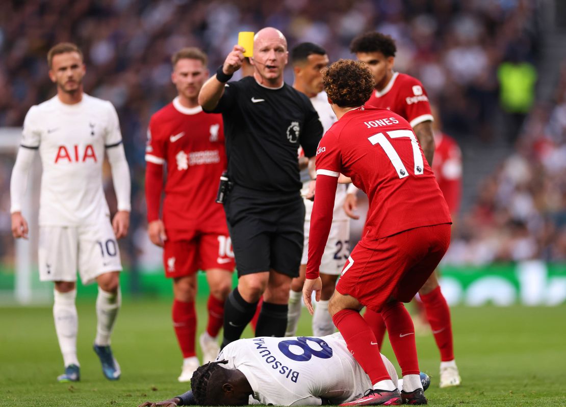 LONDON, ENGLAND - SEPTEMBER 30: Simon Hooper shows Curtis Jones of Liverpool a yellow card of a foul on Yves Bissouma of Tottenham Hotspur later upgraded to red after a VAR review during the Premier League match between Tottenham Hotspur and Liverpool FC at Tottenham Hotspur Stadium on September 30, 2023 in London, England. (Photo by Marc Atkins/Getty Images)