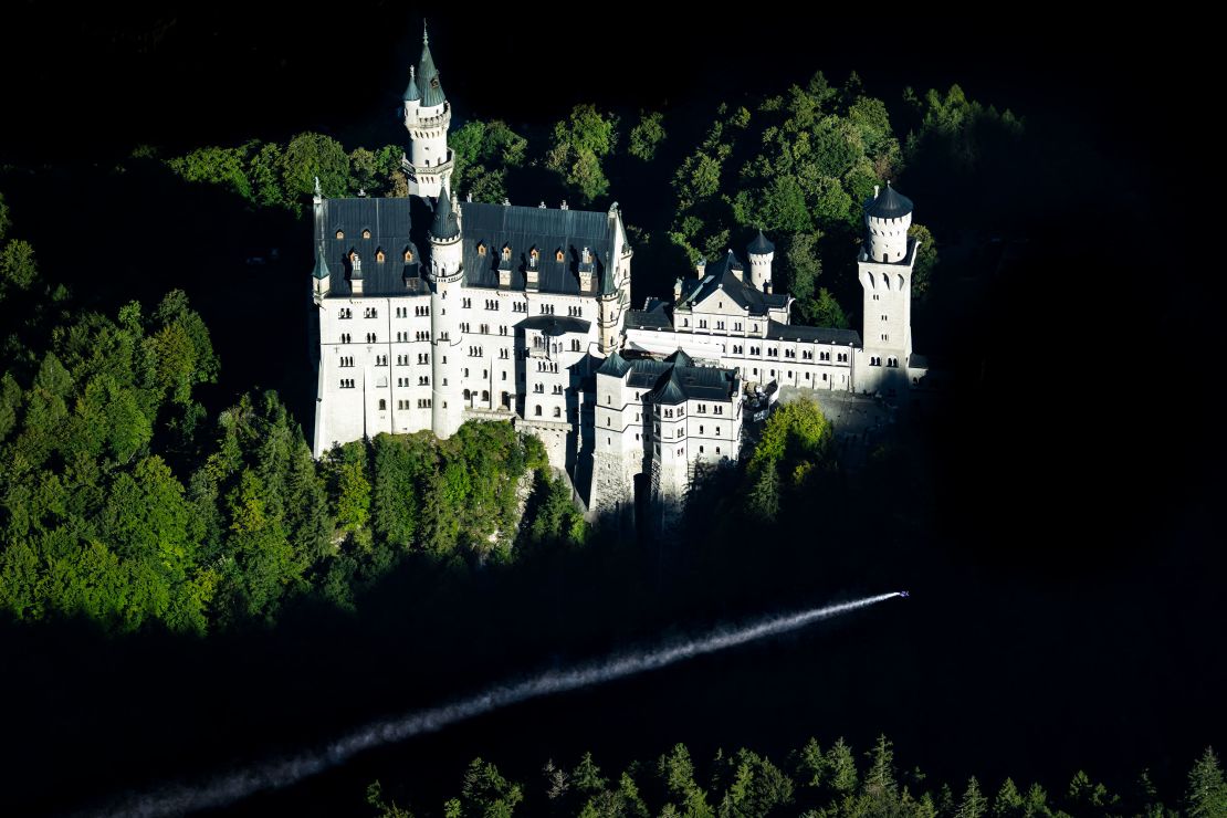 Renowned German B.A.S.E. jumper and skydiver, Max Manow, embarked on an exhilarating flight beside Neuschwanstein Castle in Germany. Using a specialised wingsuit system, he captured a unique view of the iconic Bavarian landmark. Starting from the Tegelberg cable car station in Schwangau, Manow made the most of favorable weather and launched his paraglider at 5,465 feet, covering a distance of about 2.5 kilometers. // Max Manow of Germany seen in front of the Neuschwanstein Castle in Schwangau, Bavaria, Germany on September 20, 2023 // Joerg Mitter / Red Bull Content Pool via AP Images  // For more content, pictures and videos like this please go to http://www.redbullcontentpool.com