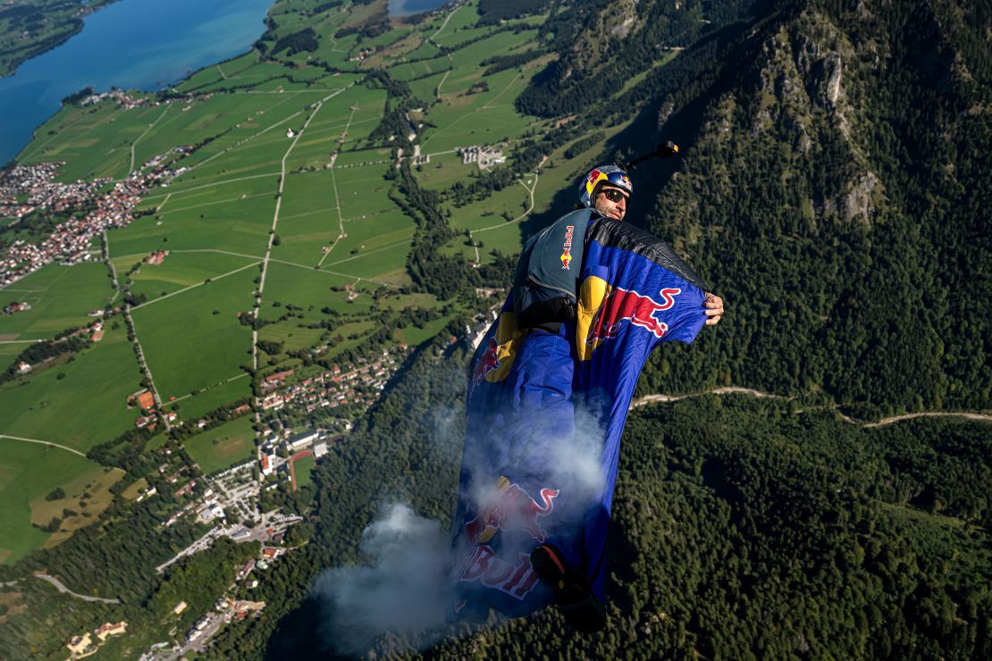 Renowned German B.A.S.E. jumper and skydiver, Max Manow, embarked on an exhilarating flight beside Neuschwanstein Castle in Germany. Using a specialised wingsuit system, he captured a unique view of the iconic Bavarian landmark. Starting from the Tegelberg cable car station in Schwangau, Manow made the most of favorable weather and launched his paraglider at 5,465 feet, covering a distance of about 2.5 kilometers. // Max Manow of Germany wingsuit flying over the Neuschwanstein Castle in Schwangau, Bavaria, Germany on September 20, 2023 // Joerg Mitter / Red Bull Content Pool via AP Images  // For more content, pictures and videos like this please go to http://www.redbullcontentpool.com